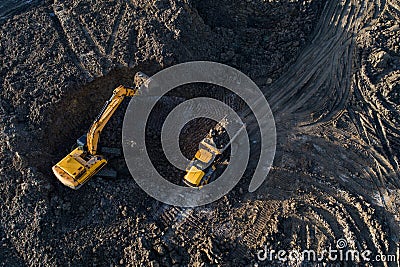 Aerial drone view of excavator loading the tipper truck Stock Photo