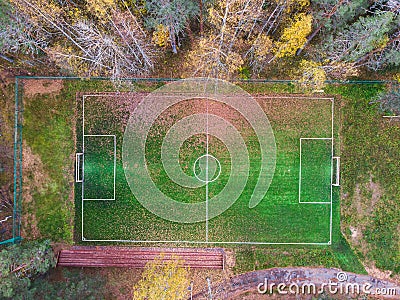 Aerial drone view of football soccer pitch field, green grass fall autumn vibrant pitch playground with fallen multicolored leaves Stock Photo
