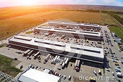 Aerial drone view of group of large modern industrial warehouse or factory buildings in suburban city area.Logistic transportation Stock Photo