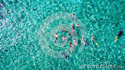 Aerial drone view of group of people snorkelling in tropical blue waters Editorial Stock Photo