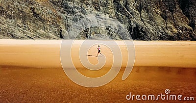 Aerial Drone View Of Healthy Sportive Woman Running On Beach Stock Photo