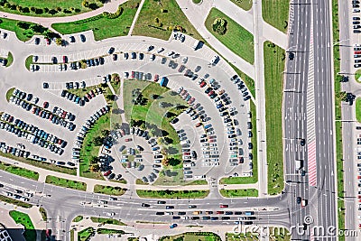 Aerial drone view of large parking lot and car traffic on city street Editorial Stock Photo