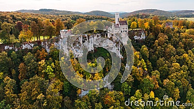 Aerial drone view medieval Lichtenstein castle on mountain, autumn Baden-Wurttemberg, Germany. Stock Photo
