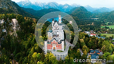 Aerial drone view Neuschwanstein castle on Alps background in vicinity of Munich, Bavaria, Germany, Europe. Autumn Stock Photo