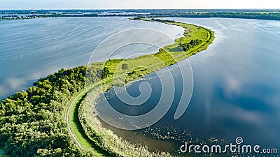 Aerial drone view of path on dam in polder water from above, landscape and nature of North Holland, Netherlands Stock Photo