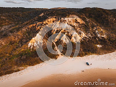 Aerial Drone view of The Pinnacles, Colored Sands on Fraser Island, Sunrise with car. Kgari, Queensland, Australia. Stock Photo