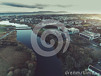 Aerial drone view on River Corrib and Galway city, Blue hour, cold color. NUI buildings and bridge. Atlantic ocean and Burren Editorial Stock Photo