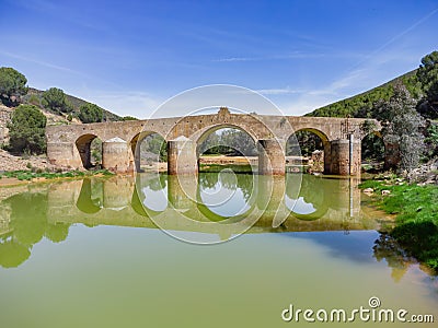 roman bridge in the hiking route of the water mills along the Odiel river from Sotiel Coronada, in Huelva Stock Photo