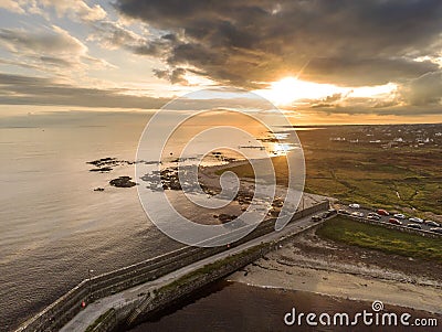 Aerial drone view on a Spiddal stone pier. County Galway, Ireland. Atlantic ocean, Sunset time. Dramatic sky Stock Photo