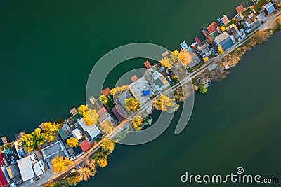 Aerial drone view of tiny fishing island on Lake Kavicsos near Budapest. The island is full with fishing huts, piers and cabins. Stock Photo