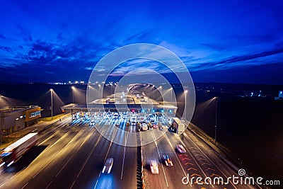 Aerial drone view on toll collection point on motorway at night. Stock Photo