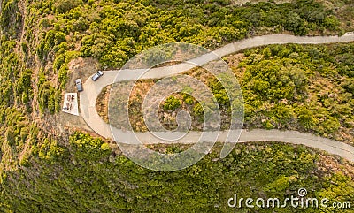 Aerial drone view of a twisty road on the countryside in Corfu Greece. Stock Photo