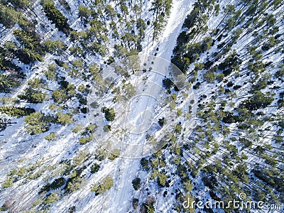 Aerial drone view of a winter road landscape. Snow covered forest and road from the top. Sunrise in nature from a birds eye view Stock Photo