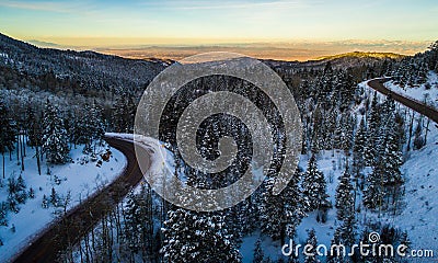 Aerial drone views of Sunset and Winding Mountain Road high in the Mountains Stock Photo