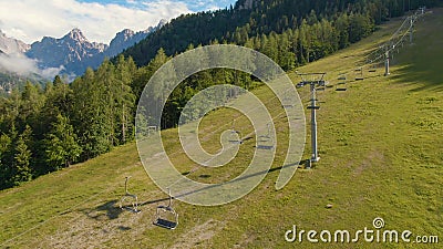 AERIAL: Flying along an empty chairlift not working the summer off-season. Stock Photo