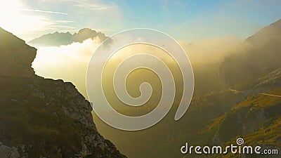 AERIAL: Flying over the idyllic grassy mountains in Slovenia at cloudy sunset. Stock Photo