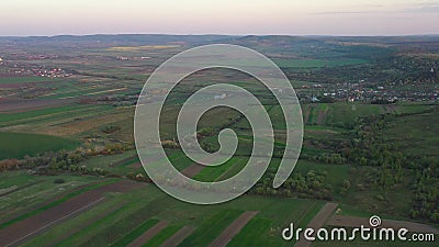 Aerial footage of an agricultural area and green rolling fields. Stock Photo