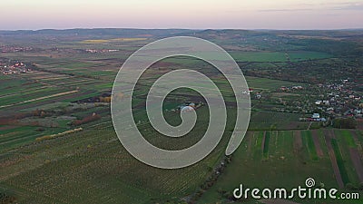 Aerial footage of an agricultural area and green rolling fields. Stock Photo