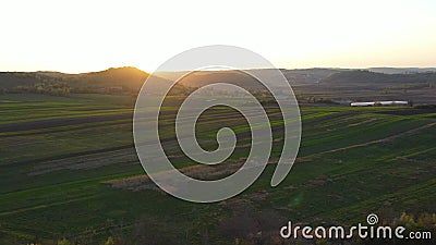 Aerial footage of an agricultural area and green rolling fields. Stock Photo