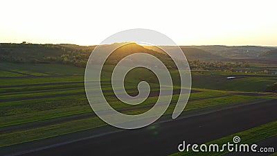 Aerial footage of an agricultural area and green rolling fields. Stock Photo