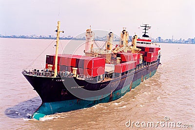 Aerial front view of a loaded container cargo vessel traveling over calm ocean Editorial Stock Photo