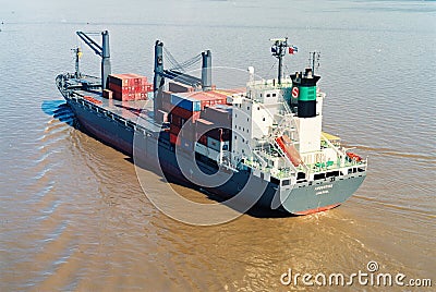 view of a loaded container cargo vessel traveling over calm ocean Editorial Stock Photo