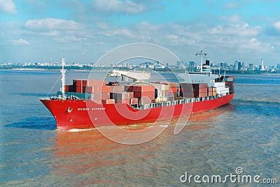 Aerial front view of a loaded container cargo vessel traveling over calm rio de la plata,buenos aires argentina,maqueira Editorial Stock Photo