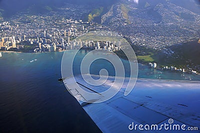 Aerial high in the sky shot of window view of plane leaving Honolulu, Hawaii Stock Photo