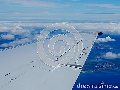 Aerial high in the sky shot of window view of plane leaving Honolulu Stock Photo