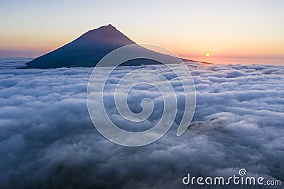 Aerial image with magical sunset over a low cloud layer covering Pico Island, with Ponta do Pico Mount Pico, the highest Stock Photo