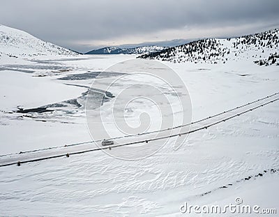 Aerial landscape with a car on the winter road Stock Photo