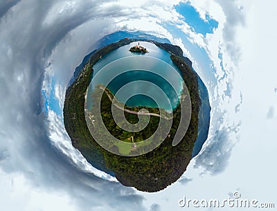Aerial little planet panoramic view of Lake Bled. Cloudy weather, heavy thunderstorm clouds on the horizon. Summer day. Season of Stock Photo