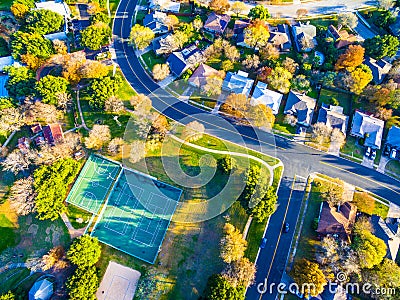 Aerial Looking down over Modern Austin Texas Countryside Community Suburbia Neighborhood with Tennis Courts and Recreational Area Stock Photo