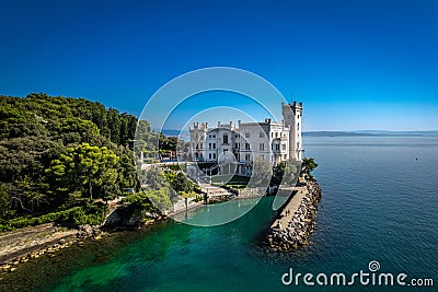 An aerial of the Miramare Castle in the scenic Gulf of Trieste in Italy captured on a bright day Stock Photo