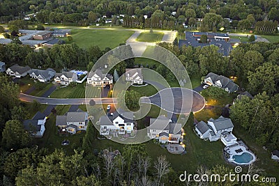 Aerial night view cul-de-sac road and spacious illuminated family houses in upstate New York suburban area. Real estate Stock Photo