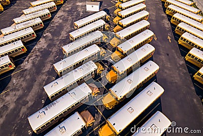 Aerial overhead photo of a parking lot full with school busses Stock Photo