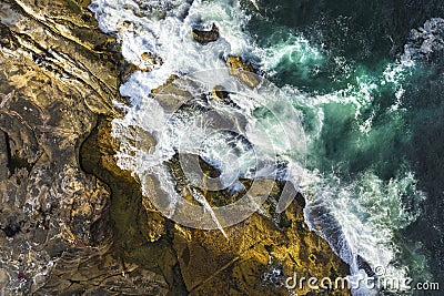 Aerial, overhead view of waves and a rocky shoreline Editorial Stock Photo