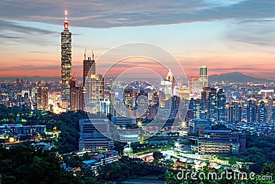 Aerial panorama of Downtown Taipei City with Taipei 101 Tower among skyscrapers under dramatic sunset sky Stock Photo