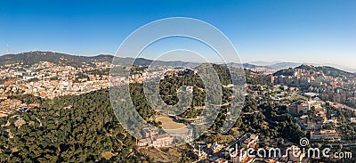 Aerial panorama drones shot of park on hill outside Barcelona city in Spain winter morning Stock Photo