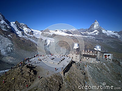 Aerial panorama of majestic mountain Matterhorn in morning sunlight with the famous Gornergrat Observatory Stock Photo