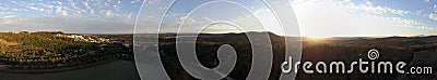 Aerial panorama over hills and polo fields at sunset Stock Photo