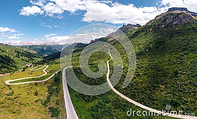 Aerial panorama view of the road for travelers on a motorcycle, car, incredible beauty views of green meadows and majestic Stock Photo