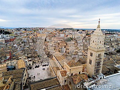 Aerial Panoramic View of the Belltower of the Cathedral of St. Maria La Bruna on Cloudy Sky at Sunset Stock Photo