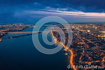 Aerial panoramic view of night city Voronezh with illuminated roads, bridges over river and high-rise buildings Stock Photo