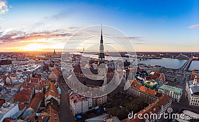 Aerial panoramic view to histirical center Riga, quay of river Daugava. Famous Landmark - st. Peter`s Church`s tower and Stock Photo