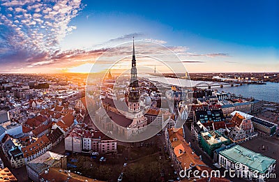 Aerial panoramic view to histirical center Riga, quay of river Daugava. Famous Landmark - st. Peter's Church's tower and Stock Photo