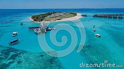 Aerial perspective of landscape tropical island luxury resort at the ocean with yachts in lagoon Stock Photo