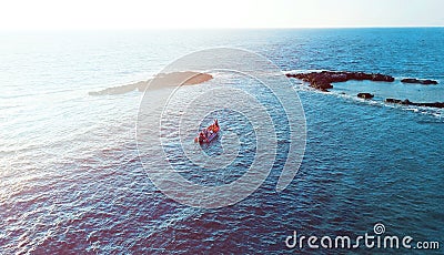 Aerial photo above rock outcrop and reef in crystal clear warm water. Stock Photo