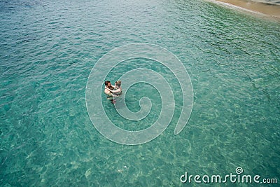 Aerial photo of young couple on holidays swimming in ocean Stock Photo