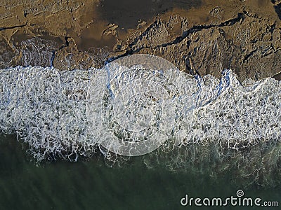 Aerial photograph of a rocky coastline with arriving and breaking ocean waves Stock Photo